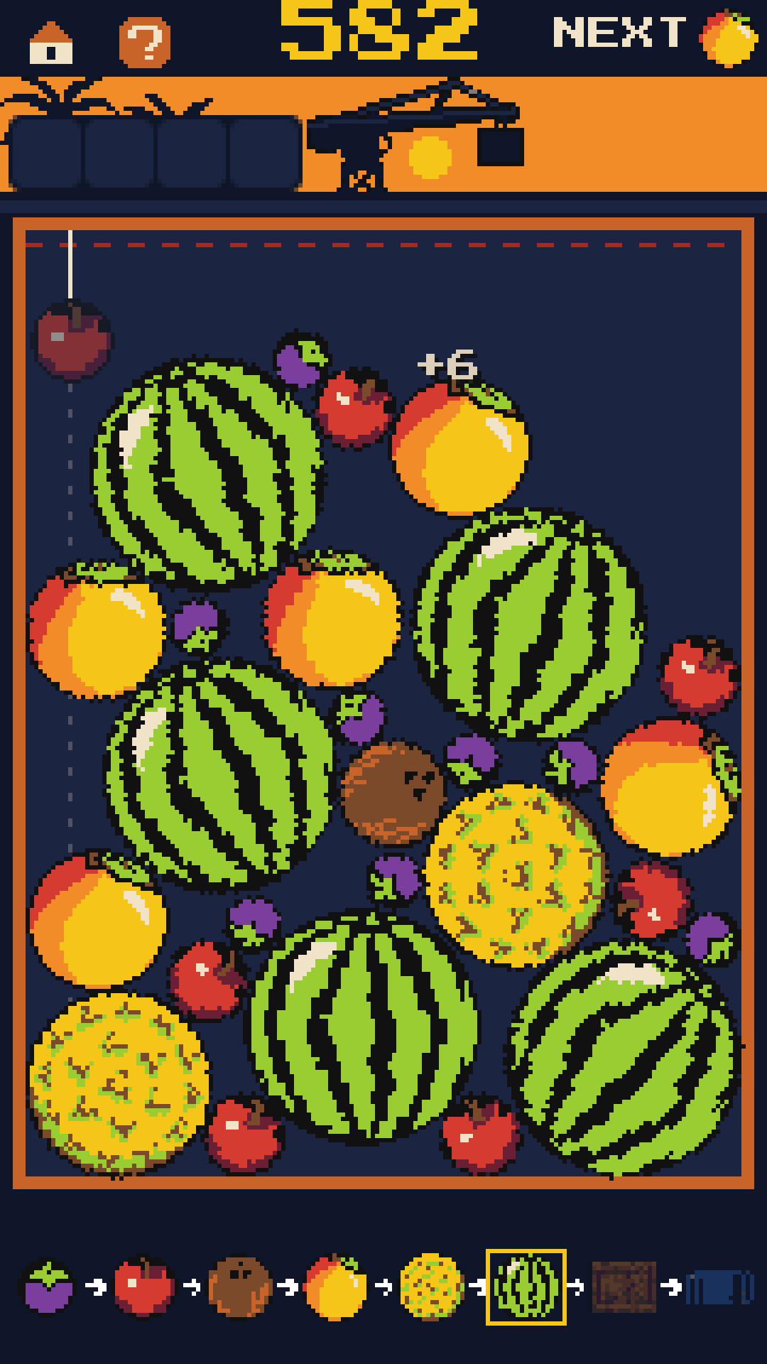 The hold: watermelons, mangoes and coconuts piled under the crane, the next piece shown at the top